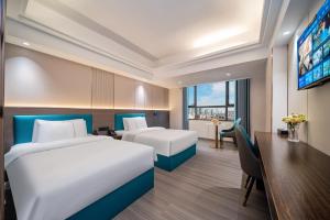 Postel nebo postele na pokoji v ubytování Mei Gang Hotel