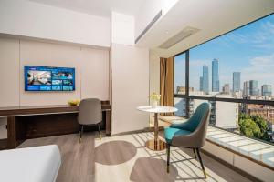 TV a/nebo společenská místnost v ubytování Mei Gang Hotel