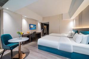 Postel nebo postele na pokoji v ubytování Mei Gang Hotel