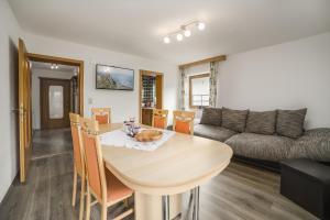 a living room with a table and a couch at Ferienhaus Oberanger in Kaltenbach