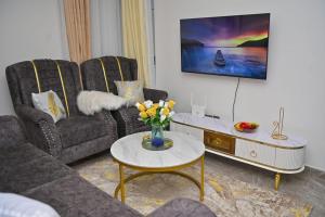 a living room with a couch and a table at Nicestay Homes in Nairobi