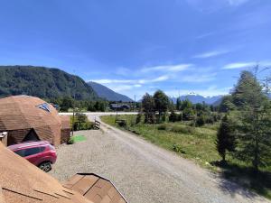 a car parked on the side of a dirt road at Domotel Aysen 4 personas excelente conectividad in Puerto Aisén