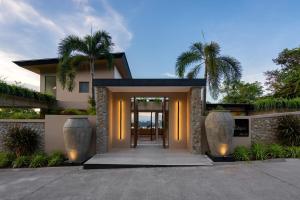 ein Haus mit Palmen davor in der Unterkunft Villa Kelapa Koh Samui in Koh Samui 