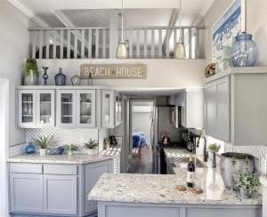 a kitchen with white cabinets and marble counter tops at Blue Pacific in Fort Bragg