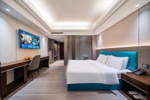 TV a/nebo společenská místnost v ubytování Mei Gang Hotel