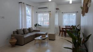 a living room with a couch and a table at Balay Hermosa in Dauis