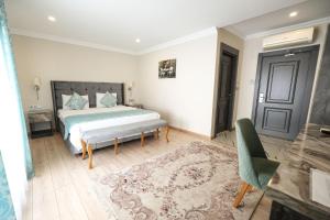 A bed or beds in a room at Florya Novi Hotel