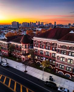 a view of a city at sunset with buildings at 3 bdrm stay! Trippy King Suite by Dwtwn Nwk in Newark