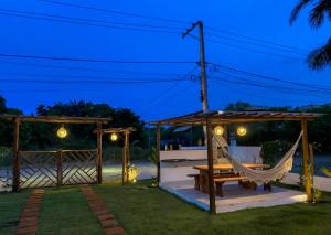 a hammock and a gazebo at night at Recanto dos Corais in Marau