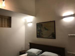 a bedroom with two beds and two lights on the wall at Lake Villa 21 in Kundasale +12 photos