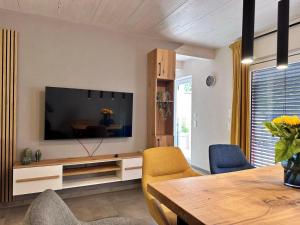 a living room with a flat screen tv on a wall at Ferienhaus rausZeit in Dernau