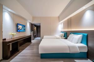 TV a/nebo společenská místnost v ubytování Mei Gang Hotel