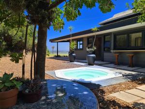 a backyard with a swimming pool and a house at Island Lake Villa and Bungalow in Wilderness