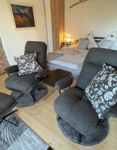 a bedroom with a bed and two chairs and a bed at Ferienhaus Langer in Bad Endorf