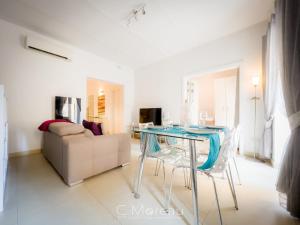 a living room with a glass table and a couch at Valletta Charming 2 Bedroom Apt in Valletta