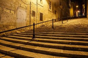 a set of stairs in an alley at night at Valletta Charming 2 Bedroom Apt in Valletta