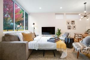 a living room with a bed and a tv at Perch - Ballard Bliss in Seattle