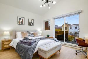 a bedroom with a bed and a large window at Perch - Ballard Bliss in Seattle