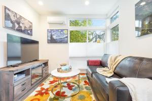 a living room with a couch and a tv at Perch - Roosevelt Retreat in Seattle