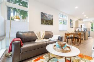 a living room with a couch and a table at Perch - Roosevelt Retreat in Seattle