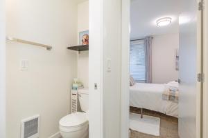 a white bathroom with a toilet and a bed at Perch - Roosevelt Retreat in Seattle +34 photos