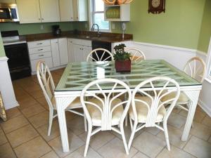 a kitchen with a table with four chairs and a counter at KH5203- Katmantoo in Kitty Hawk