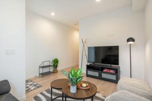 a living room with a couch and a table at Perch - Sand Point Haven in Seattle