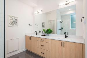 a bathroom with a sink and a large mirror at Perch - Sand Point Haven in Seattle +39 photos