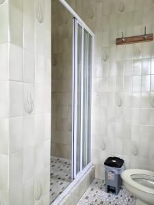 a bathroom with a toilet and a glass shower at 9 Spiritual Fruits in Durban +35 photos