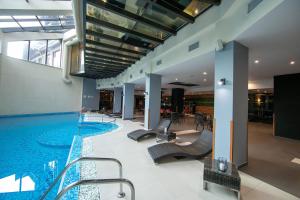 a large swimming pool in a building with a swimming pool at Iceberg Apartment 50 in Borovets