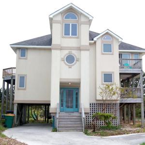 a large white house with a balcony at M906- Castle De La Mar in Corolla
