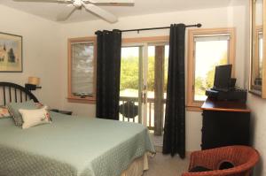 a bedroom with a bed and a window at M906- Castle De La Mar in Corolla +23 photos