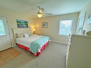 a bedroom with a bed and a ceiling fan at KD202- "St. Somewhere" at Playa Del Ray in Kill Devil Hills +31 photos