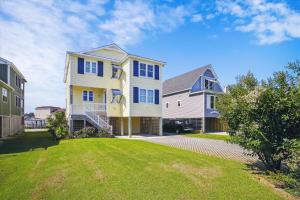 a large house with blue windows and a yard at CH219C - Southern Jewel in Kill Devil Hills