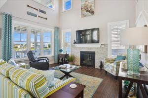 a living room with a couch and a fireplace at CH219C - Southern Jewel in Kill Devil Hills
