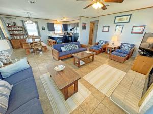 a living room with blue couches and a table at KD2709- La Dolce Far Niente in Kill Devil Hills