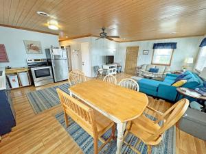 a living room with a table and a blue couch at KH4300- Weather Station in Kitty Hawk