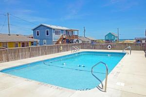 a large blue swimming pool in front of a wooden fence at KH4300- Weather Station in Kitty Hawk