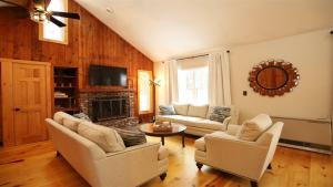 a living room with two couches and a fireplace at Bell Valley 146, Estates in Campton