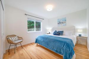 a bedroom with a bed and a chair and a window at Perch - Seascape Summit in Oak Harbor