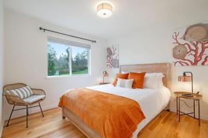 a bedroom with a bed and a chair and a window at Perch - Seascape Summit in Oak Harbor