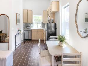a kitchen with a table and chairs in a room at Perch - Baker's Acres in Langley