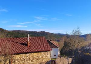 a house with a red roof and a fence at Apartmán Amálka in Ktiš