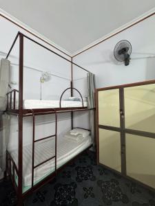 a room with two bunk beds and a glass door at Tam Coc Sunrise Homestay in Ninh Binh