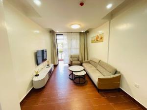 a living room with a couch and a table at queens luxurious apartment kigali in Kigali