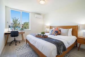 a bedroom with a bed and a desk and a window at Perch - Urban Reflection 13 in Seattle