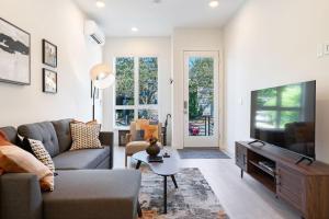 a living room with a couch and a tv at Perch - Urban Reflection 13 in Seattle