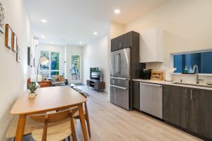 a kitchen with a table and a refrigerator at Perch - Urban Reflection 13 in Seattle