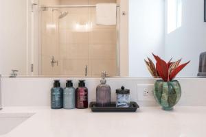 a bathroom with a sink with bottles on a counter at Perch - Urban Reflection 13 in Seattle +33 photos