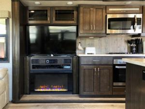 a kitchen with an oven with a fire in it at Driftwood in Fort Bragg +12 photos